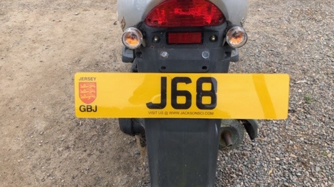 The huge J68 Number Plate on the rear of the Scooter